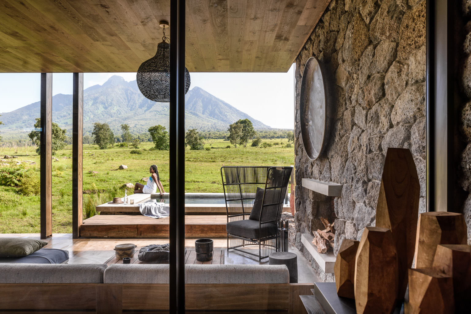 Suite lounge with volcano views at a luxury gorilla trekking lodge in Rwanda