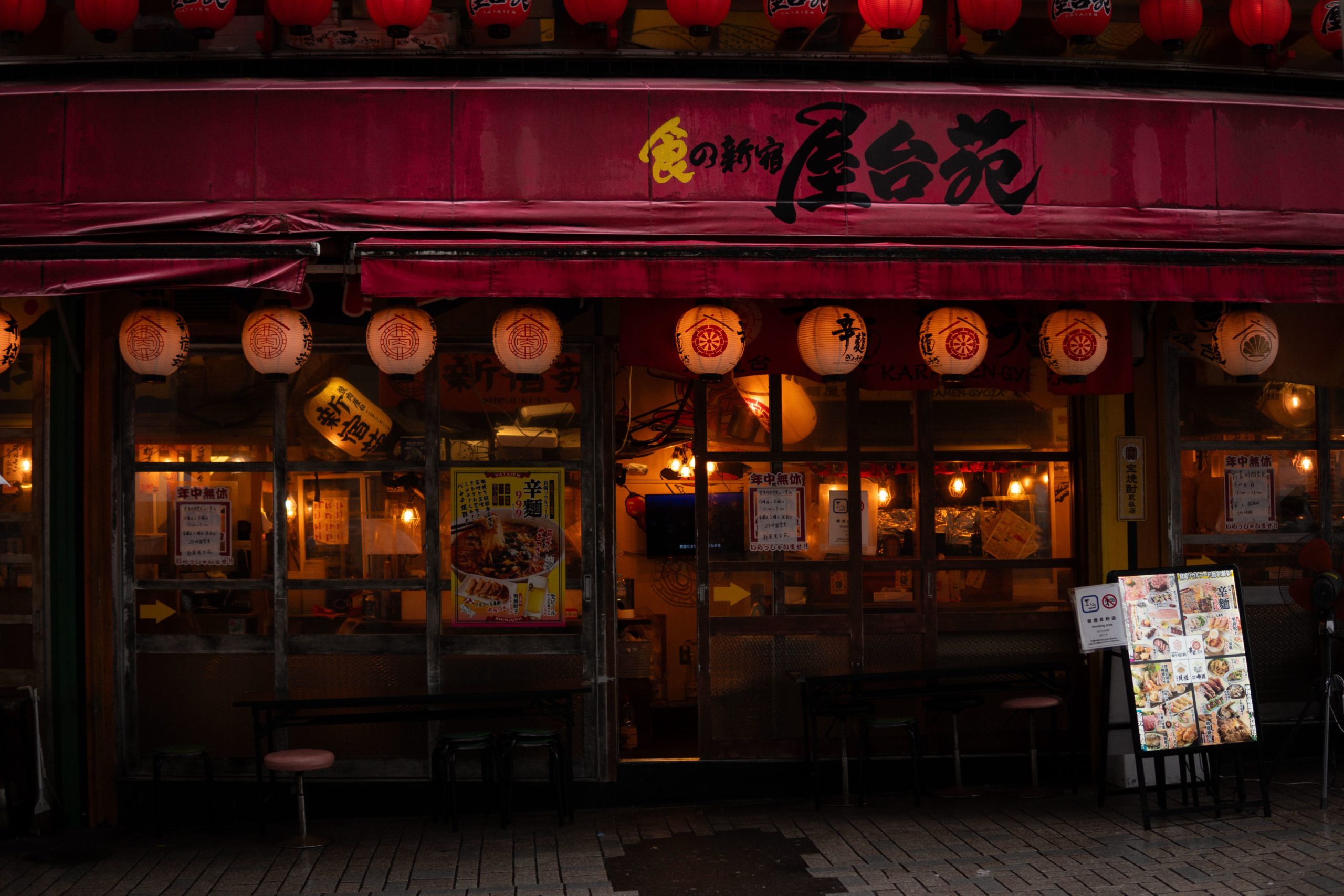 Busy Tokyo alleyway with lanterns and small eateries, capturing the energy of street food tours and eating like a local in the city