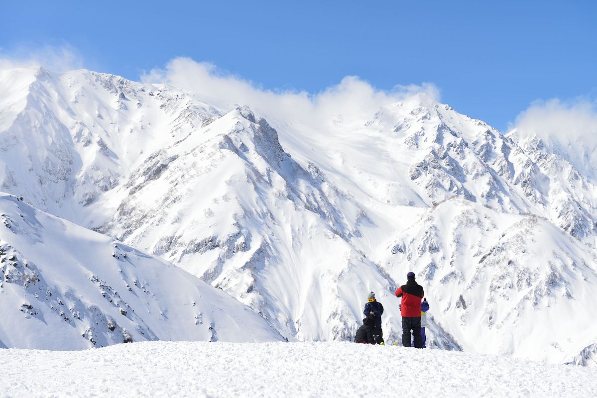 Skiers taking in the snow-covered peaks of the Northern Alps above Hakuba in Nagano Prefecture