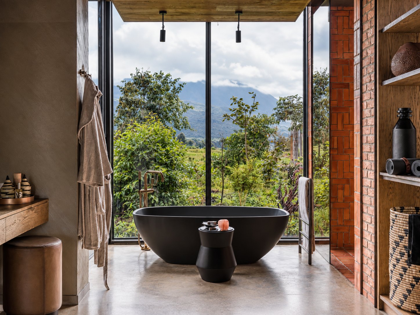 A freestanding bathtub with panoramic views of the Virunga volcanoes at a luxury lodge near Volcanoes National Park, Rwanda